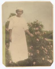 Woman standing next to flowers