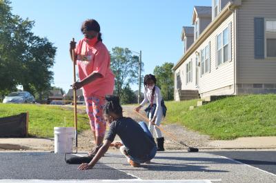 Three girls painting the street