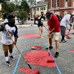Community members painting the Black Lives Matter street mural with Mayor Chris Cerino