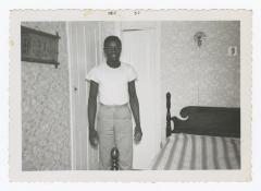 A man standing in a bedroom
