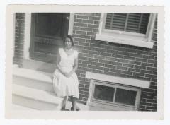 Woman sitting outside door 609