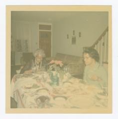 Two women sitting at a dining room table