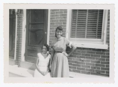 Two women posing outside