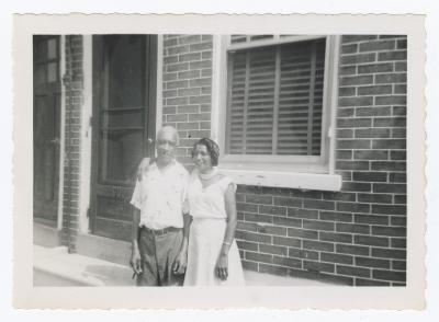 A man and woman standing outside door 609