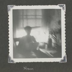 A blurry photograph of a woman reading 