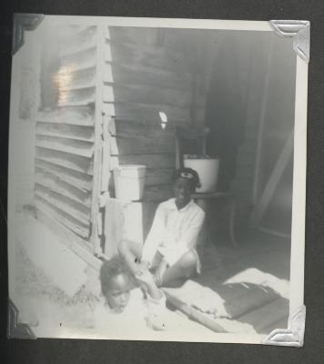 A young girl on a porch with a child