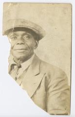 An older man in a flat hat