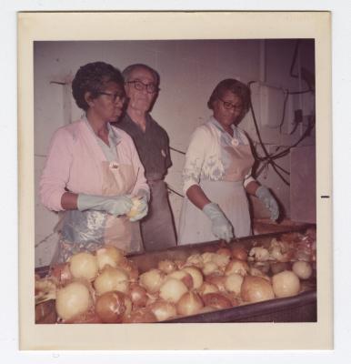 Sorting through yellow onions at VITA Foods