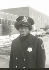 Unidentified African American female police officer acting as a crossing guard for Garnet School