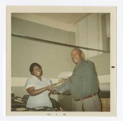 Florence Tinch handing out VITA Foods uniforms
