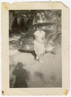 Woman leaning against car