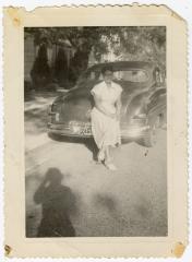 Woman leaning against car