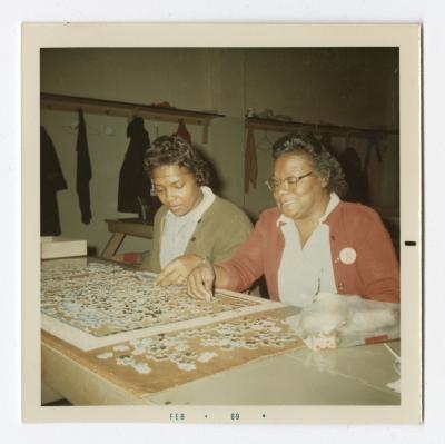Dorothy Kennard Hutchins and Lena Clark working on a puzzle during their work break at VITA Foods