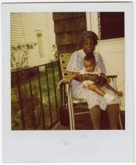 Polaroid of Fannie Wilson holding a baby