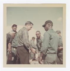 Men chatting at the Annual VITA Foods Cookout