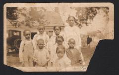 Hutchins children posing before a house