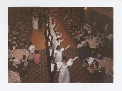 Debutantes exiting with escorts from the ballroom floor
