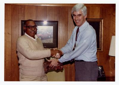 Sam Ringgold Sr. shaking hands with manager for his 25th anniversary at General Motors