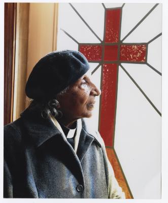 Reverend Mae Etta Moore looking out a window