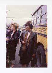 Ms. Erlena Linthicum by a school bus