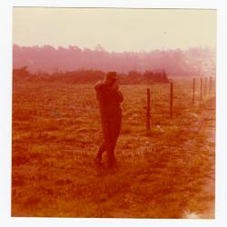 Eleanor Rochelle Ringgold leaning on a fence post