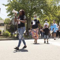 Woman leading march with bullhorn
