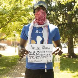 Young man holding protest sign 